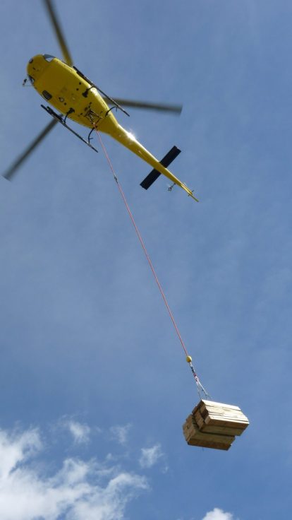 Vue rapprochée d'un héliportage de caisse en bois suspendue